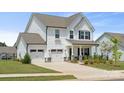 Beautiful two-story home with a three-car garage, stone accents, and a well-manicured lawn at 12001 Sam Snead Ct, Lancaster, SC 29720