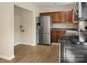 Functional kitchen with stainless steel refrigerator and plentiful cabinets at 1218 Milan Rd, Charlotte, NC 28216