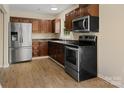 Updated kitchen featuring stainless steel appliances and ample cabinet space at 1218 Milan Rd, Charlotte, NC 28216