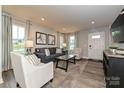 Inviting living room with a comfortable sofa, accent chairs, and a view of the front entry at 124 Kristin View Ln # Townhome A, Troutman, NC 28166