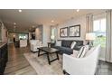 Bright living room featuring neutral walls, accent chairs, stylish decor, and luxury vinyl flooring at 124 Kristin View Ln # Townhome A, Troutman, NC 28166