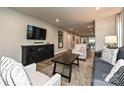 Open-concept living room featuring modern furnishings and flows into the kitchen and dining area at 124 Kristin View Ln # Townhome A, Troutman, NC 28166