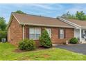 Charming brick townhouse with manicured landscaping and a well-maintained front yard at 130 24Th Nw St, Hickory, NC 28601