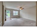 Bright living room featuring neutral carpet, ceiling fan, and ample natural light at 130 24Th Nw St, Hickory, NC 28601