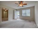 Bright living room featuring neutral carpet, ceiling fan, and ample natural light at 130 24Th Nw St, Hickory, NC 28601