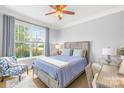 Cozy bedroom with a large window, ceiling fan, chair and desk, offering a comfortable and bright space at 138 Chase Water Dr, Mooresville, NC 28117