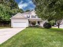 Beautiful two-story home boasting lush landscaping, a spacious front yard, and an attached garage at 1423 Piper Ct, Concord, NC 28025