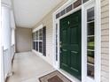 Inviting front door framed by sidelights and pillars, leading to a covered porch at 1423 Piper Ct, Concord, NC 28025