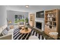 Bright living room with a fireplace, a large window, and stylish furnishings at 1523 Merrie Meadow Ct, Rock Hill, SC 29732