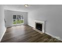 Bright living room with a fireplace, wood flooring, and a large window at 1523 Merrie Meadow Ct, Rock Hill, SC 29732