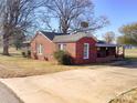 Charming brick home with a covered porch and a spacious driveway at 176 Travis Loop, Statesville, NC 28625