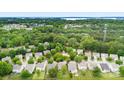 An aerial view showcases the neighborhood's lush tree cover and proximity to the lake at 18522 Victoria Bay Dr, Cornelius, NC 28031