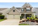 Attractive two-story home with a two-car garage, stone accents, and a covered front porch at 18522 Victoria Bay Dr, Cornelius, NC 28031