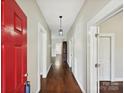 Hallway features hardwood floors, neutral walls, and white trim, with a glimpse of other rooms at 214 Tenth St, Cramerton, NC 28032