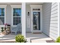 Inviting front porch featuring a welcome sign and lovely chairs at 3038 Burnello Ct, Iron Station, NC 28080