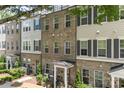 A row of modern townhomes features brick and siding, enhanced by manicured greenery at 318 N Dotger Ave, Charlotte, NC 28204
