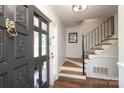 Inviting entryway with hardwood floors, staircase, and a decorative front door showcasing the home's stylish interior at 3604 Golfview Dr, Gastonia, NC 28056