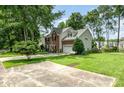 A brick and vinyl home with a well-maintained lawn and concrete driveway at 3810 Yorkford Dr, Charlotte, NC 28269