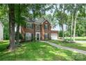 Inviting brick home with well-kept lawn and landscaping, showcasing curb appeal at 3810 Yorkford Dr, Charlotte, NC 28269