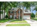 Charming brick home featuring a well-manicured lawn and a two-car garage at 3810 Yorkford Dr, Charlotte, NC 28269