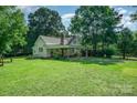 Expansive backyard featuring a covered patio area, picnic table, and lush green lawn perfect for outdoor activities and relaxation at 4612 Rehobeth Rd, Waxhaw, NC 28173
