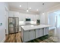 Modern kitchen featuring stainless steel appliances, a large island, and elegant pendant lighting at 4714 Blanchard Way, Charlotte, NC 28226
