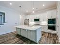 Spacious kitchen with sleek white cabinets, stainless steel appliances, and an island with a sink at 4714 Blanchard Way, Charlotte, NC 28226