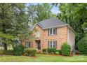 Brick two-story home with manicured lawn and mature trees at 4808 Cobble Glen Way, Charlotte, NC 28269