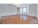 Formal dining room with hardwood floors, wainscoting, and a bay window offering ample natural light at 5008 Woodview Ln, Weddington, NC 28104