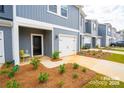 Inviting townhome featuring a well-maintained front yard and convenient one-car garage at 508 Tayberry Ln, Fort Mill, SC 29715