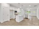 Open-concept kitchen with stainless steel appliances, a center island, and bright white cabinetry at 5175 Grand Canyon Rd, Concord, NC 28027