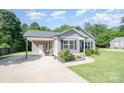 Beautiful home with a carport, manicured lawn, and tidy landscaping at 613 Gold Hill Dr, Salisbury, NC 28146