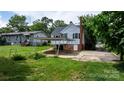 A home with a carport, leading to the backyard with some shade from nearby trees at 626 1St Se Ave, Hickory, NC 28602