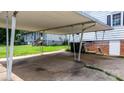 The carport has a concrete floor and white support beams at 626 1St Se Ave, Hickory, NC 28602