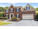 Beautiful brick two-story home with lush landscaping, a two car garage, and a covered front entrance at 7213 Baniff Cir, Charlotte, NC 28277