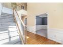 Bright foyer with hardwood floors, staircase with white railing, and access to multiple rooms at 1002 Hollyhedge Ln, Indian Trail, NC 28079