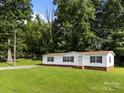 Well-maintained single-story home with a large, grassy front yard and tree coverage at 1011 Rachel Ln, Salisbury, NC 28147