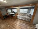 Cozy living room with built-in seating and a table, next to a fireplace at 109 Pine St, New London, NC 28127
