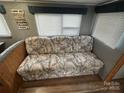 Comfortable living room with built-in seating and a cushioned sofa in a compact design at 109 Pine St, New London, NC 28127