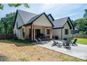 Inviting backyard with covered patio, stone fire pit, and comfortable lounge seating at 140 Robin Rd, Lincolnton, NC 28092