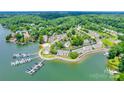 Aerial view showcases a waterfront community with boat docks, lush greenery, and serene lakeside living at 14053 Queens Harbor Rd, Charlotte, NC 28278