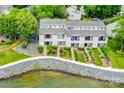 Aerial view of townhomes with well-maintained landscaping and waterfront access, offering beautiful lakeside living at 14053 Queens Harbor Rd, Charlotte, NC 28278