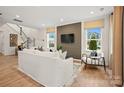 Spacious living room with large windows, modern lighting, and a decorative accent wall at 15906 Parkside Crossing Dr # 317, Charlotte, NC 28273