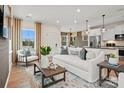Bright living room with stylish decor, including a plush sofa, accent chair, and hardwood floors at 15906 Parkside Crossing Dr # 317, Charlotte, NC 28273