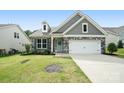Attractive home featuring stone accents, gray siding, and a neatly kept front lawn at 16112 Langston Dr, Charlotte, NC 28278