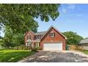 Traditional two-story red brick home with a two-car garage and well-maintained landscaping at 1624 Moonstone Dr, Matthews, NC 28105