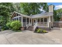 Private backyard with a screened porch, a deck, and a concrete patio perfect for entertaining at 2112 Shenandoah Ave, Charlotte, NC 28205