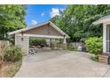 Large carport offers covered parking and extra space, with a landscaped garden nearby at 2112 Shenandoah Ave, Charlotte, NC 28205