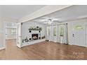 Inviting living room featuring a brick fireplace, hardwood floors, and ample natural light at 2229 Old Wilkesboro Rd, Statesville, NC 28625