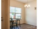 Cozy breakfast nook features a modern chandelier and a sunlit window at 2921 Parkwest Dr, Albemarle, NC 28001